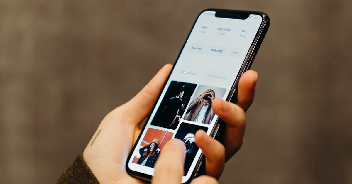 Close-up of hands using a smartphone to browse a photo gallery app, showcasing modern technology.