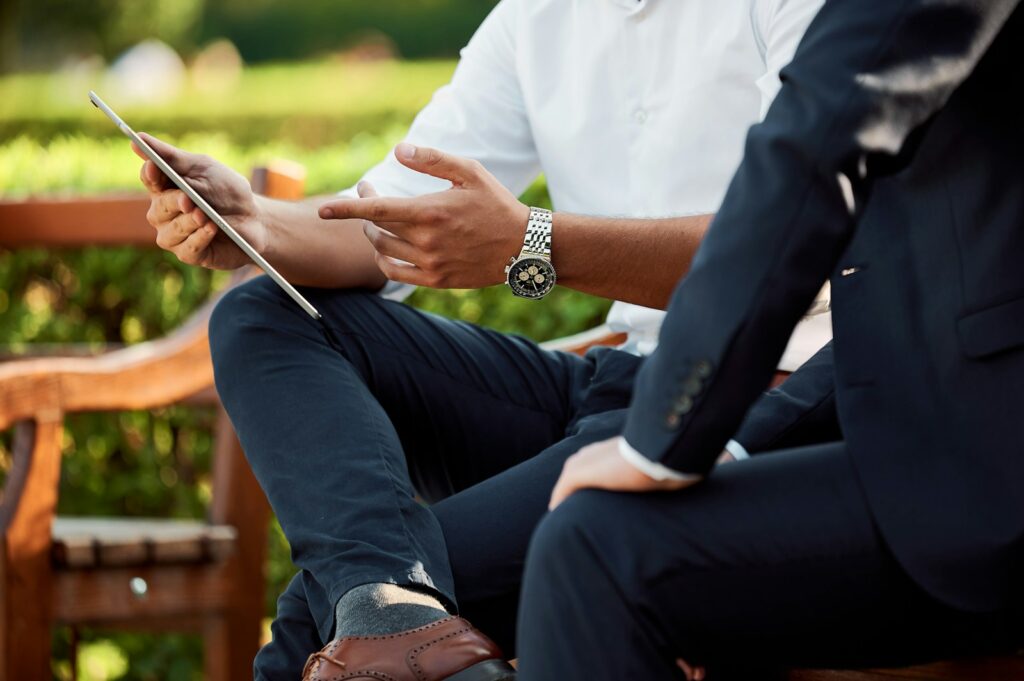 two people sitting during day talking about crm for thier small business
