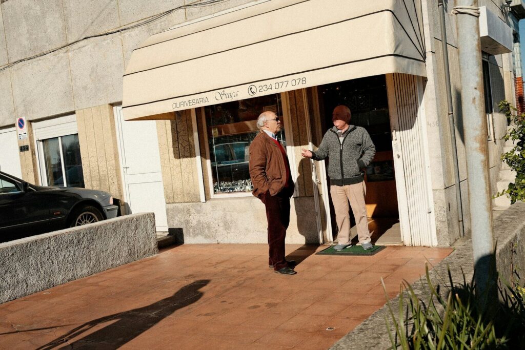 A couple of men standing outside of a building